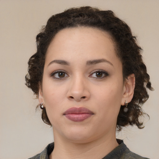 Joyful black young-adult female with medium  brown hair and brown eyes