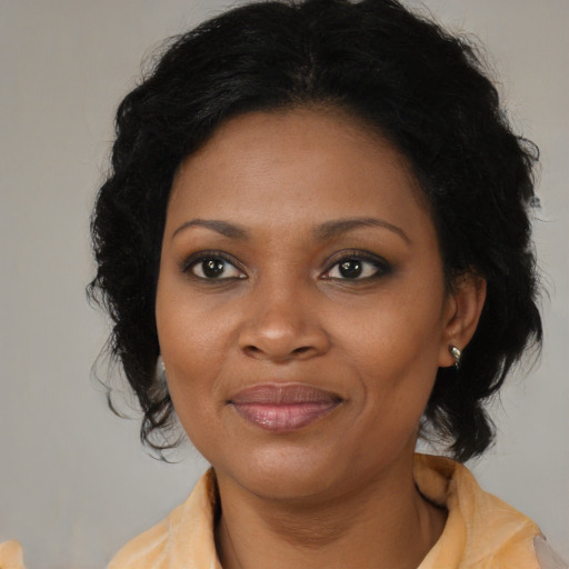 Joyful black young-adult female with medium  brown hair and brown eyes
