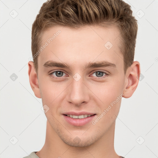 Joyful white young-adult male with short  brown hair and grey eyes