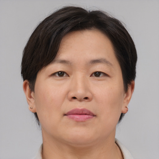 Neutral asian adult female with short  brown hair and brown eyes