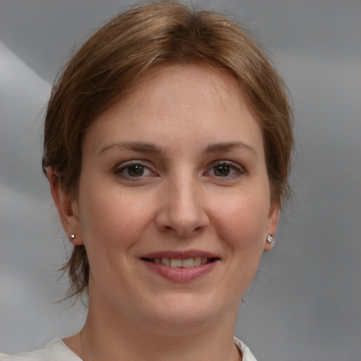 Joyful white young-adult female with medium  brown hair and brown eyes