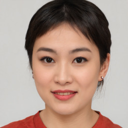 Joyful asian young-adult female with medium  black hair and brown eyes