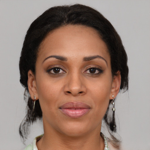 Joyful latino adult female with medium  brown hair and brown eyes