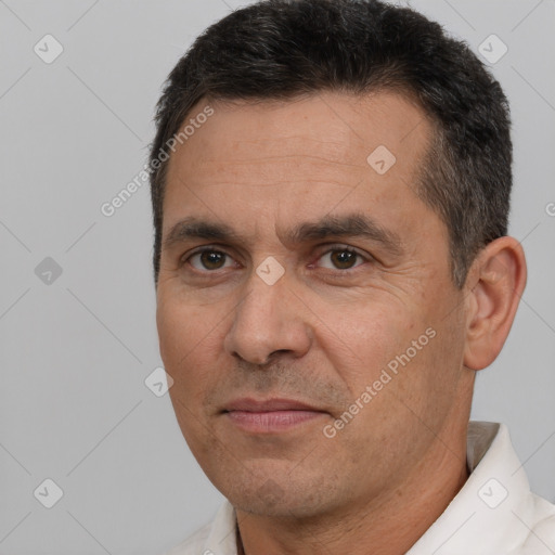 Joyful white adult male with short  brown hair and brown eyes