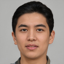 Joyful asian young-adult male with short  black hair and brown eyes