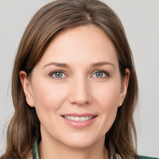 Joyful white young-adult female with medium  brown hair and grey eyes