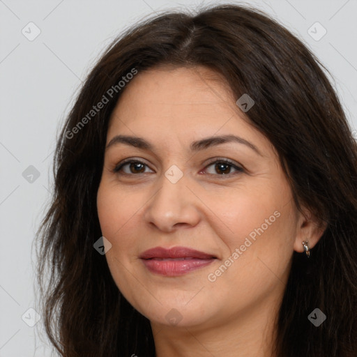 Joyful white adult female with long  brown hair and brown eyes