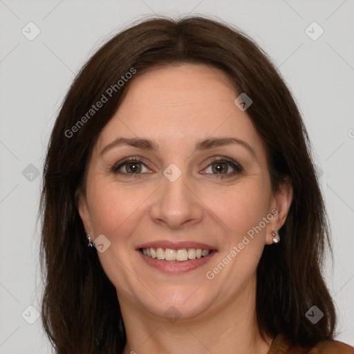 Joyful white adult female with long  brown hair and brown eyes