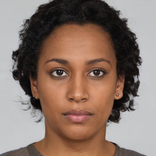 Neutral black young-adult female with short  brown hair and brown eyes