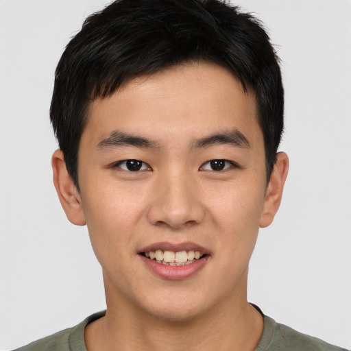 Joyful asian young-adult male with short  brown hair and brown eyes