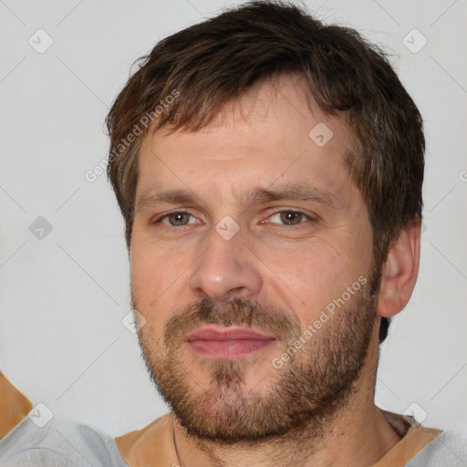 Joyful white adult male with short  brown hair and brown eyes