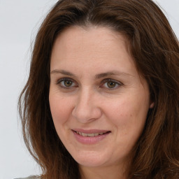 Joyful white adult female with long  brown hair and brown eyes