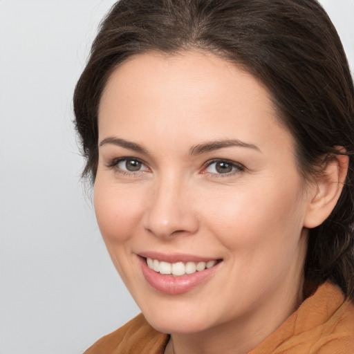 Joyful white young-adult female with medium  brown hair and brown eyes