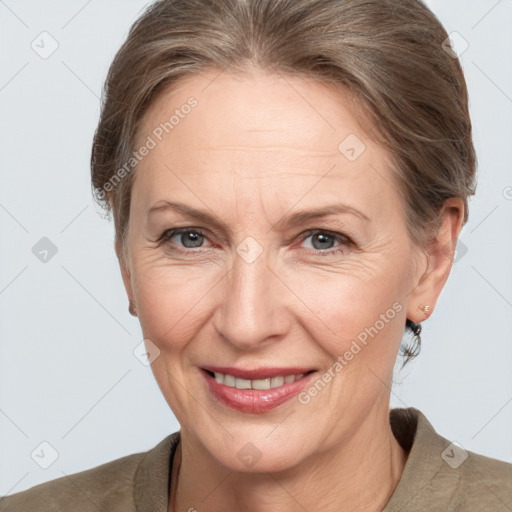 Joyful white adult female with medium  brown hair and grey eyes