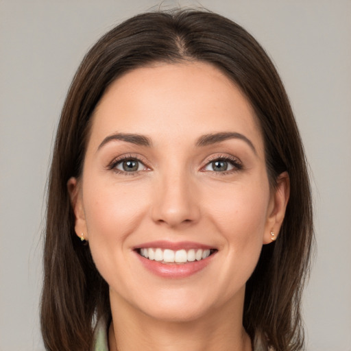 Joyful white young-adult female with medium  brown hair and brown eyes