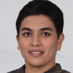 Joyful latino young-adult male with short  brown hair and brown eyes