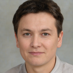 Joyful white adult male with short  brown hair and grey eyes