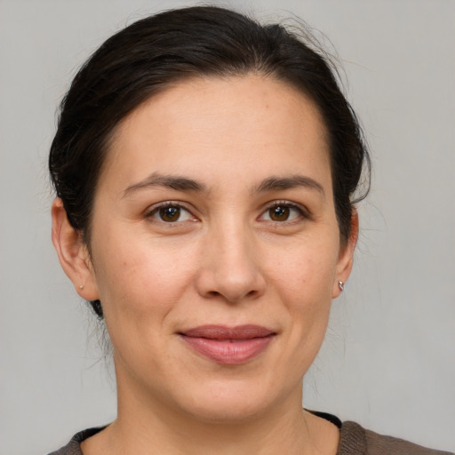 Joyful white adult female with medium  brown hair and brown eyes