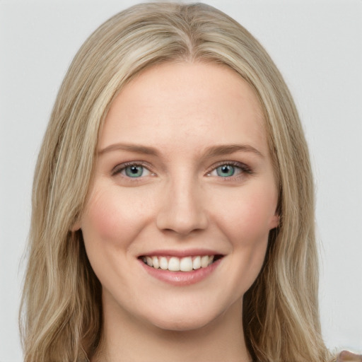 Joyful white young-adult female with long  brown hair and green eyes