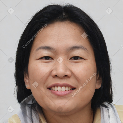 Joyful asian young-adult female with medium  brown hair and brown eyes