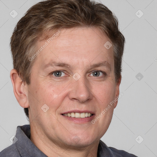 Joyful white adult male with short  brown hair and grey eyes