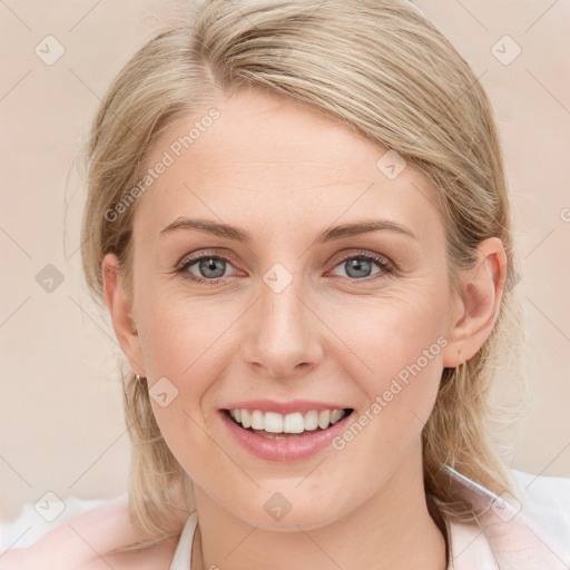 Joyful white young-adult female with medium  brown hair and blue eyes