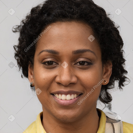 Joyful black young-adult female with long  brown hair and brown eyes