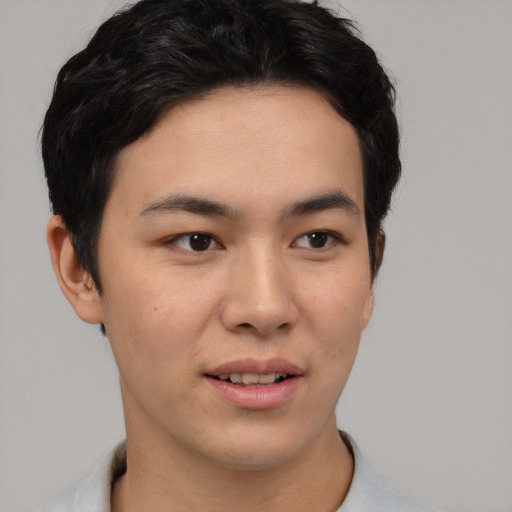 Joyful latino young-adult male with short  brown hair and brown eyes