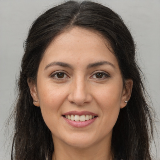 Joyful white young-adult female with long  brown hair and brown eyes