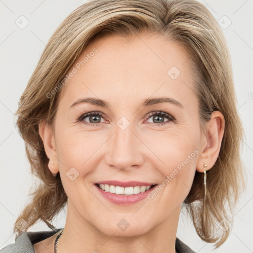 Joyful white adult female with medium  brown hair and blue eyes