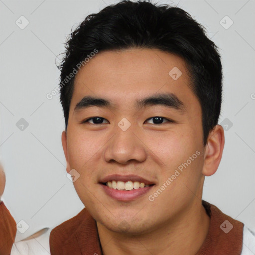 Joyful asian young-adult male with short  black hair and brown eyes