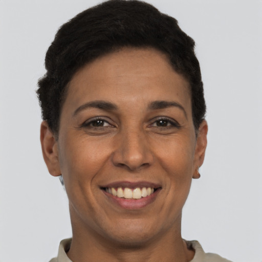 Joyful latino adult female with short  black hair and brown eyes