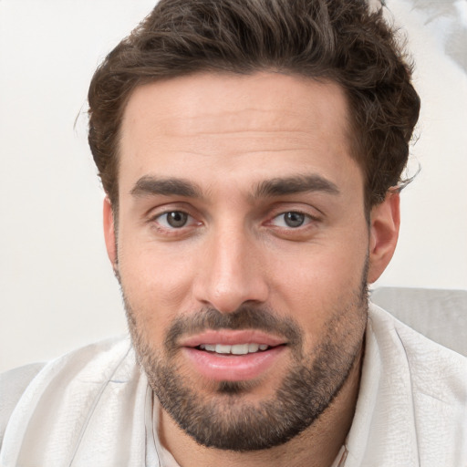 Joyful white young-adult male with short  brown hair and brown eyes