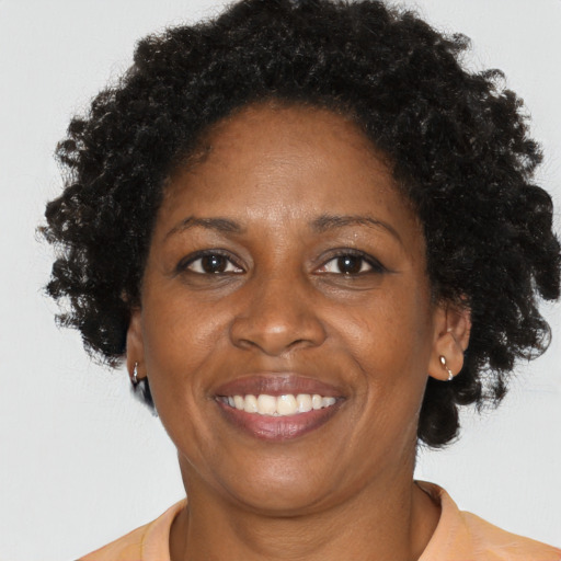 Joyful black adult female with short  brown hair and brown eyes