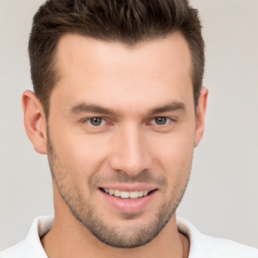 Joyful white young-adult male with short  brown hair and brown eyes