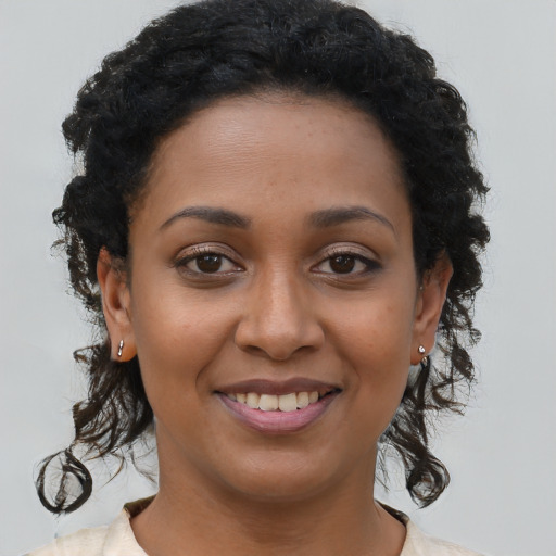 Joyful latino young-adult female with medium  brown hair and brown eyes