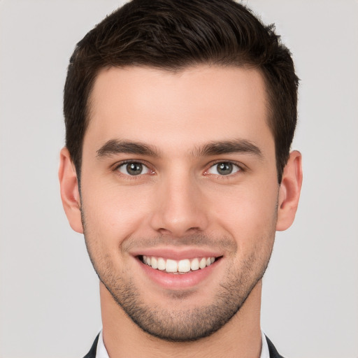 Joyful white young-adult male with short  brown hair and brown eyes