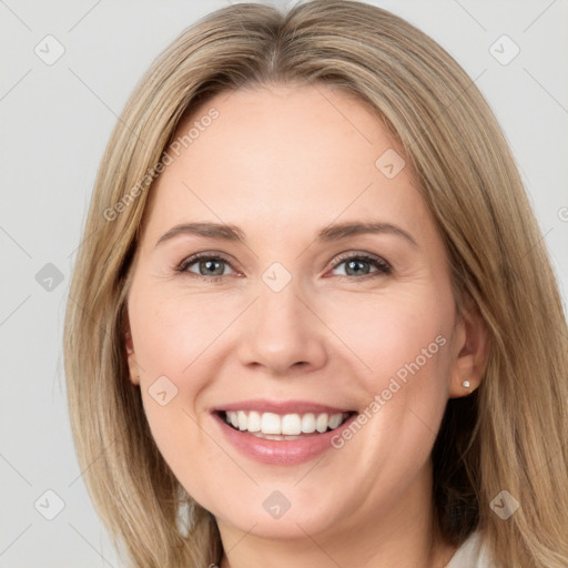 Joyful white young-adult female with long  brown hair and green eyes