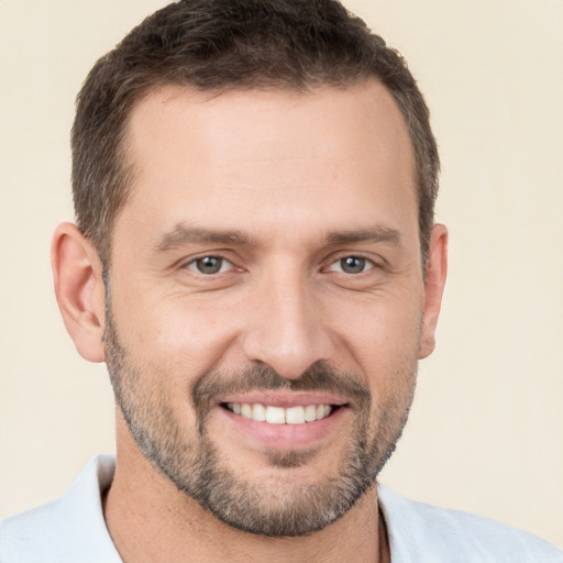 Joyful white young-adult male with short  brown hair and brown eyes