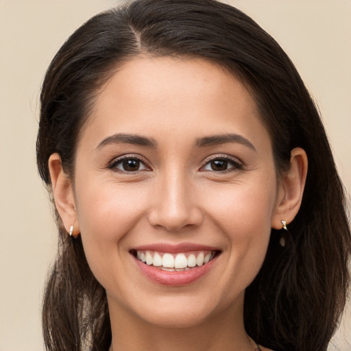 Joyful white young-adult female with long  brown hair and brown eyes