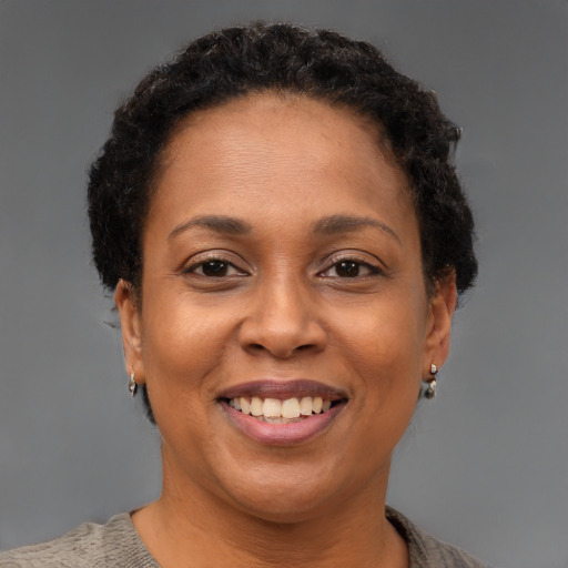 Joyful black adult female with short  brown hair and brown eyes