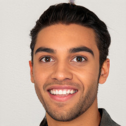 Joyful white young-adult male with short  black hair and brown eyes