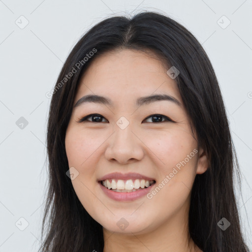 Joyful asian young-adult female with long  brown hair and brown eyes