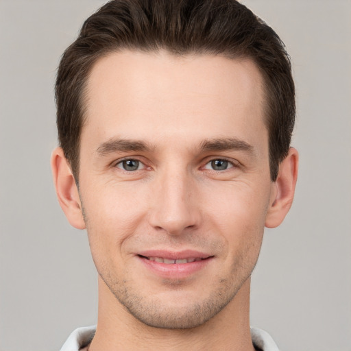 Joyful white young-adult male with short  brown hair and brown eyes