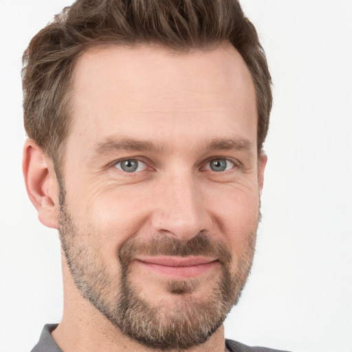 Joyful white adult male with short  brown hair and grey eyes