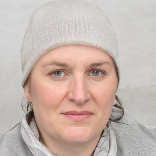 Joyful white adult female with medium  brown hair and blue eyes