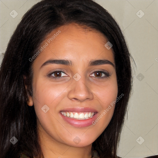 Joyful latino young-adult female with long  brown hair and brown eyes