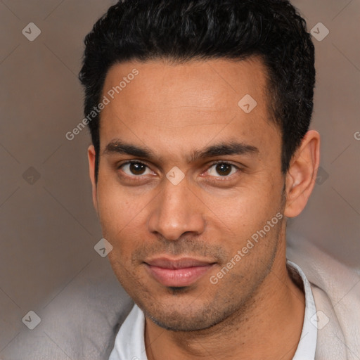 Joyful white young-adult male with short  black hair and brown eyes