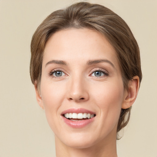 Joyful white young-adult female with medium  brown hair and green eyes