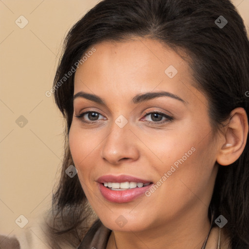 Joyful white young-adult female with long  brown hair and brown eyes